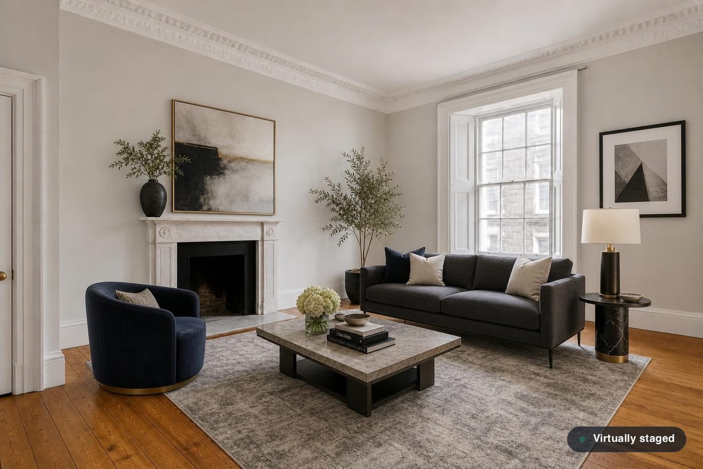 Empty Edinburgh New Town drawing room with a marble chimneypiece, deep cornice and shuttered sash window, shown before and after virtual staging with a dark sofa, swivel chair and marble coffee table — after