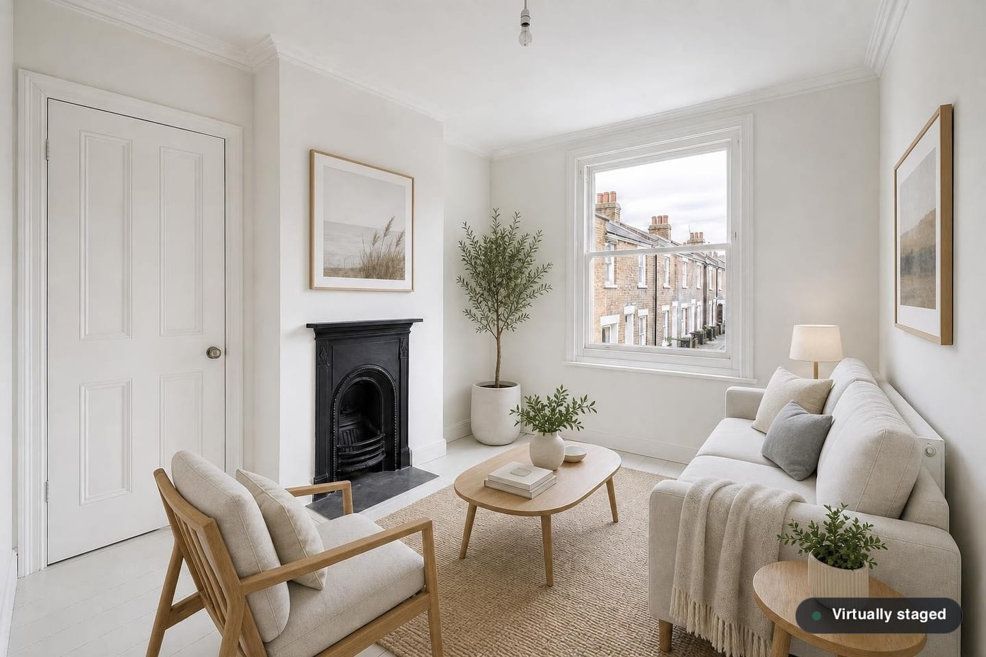 Empty compact London flat-conversion living room with a small cast-iron fireplace, a sash window onto stock-brick terraces and painted white floorboards, shown before and after virtual staging with a two-seater sofa, oak-framed armchair, small oval coffee table and jute rug — after