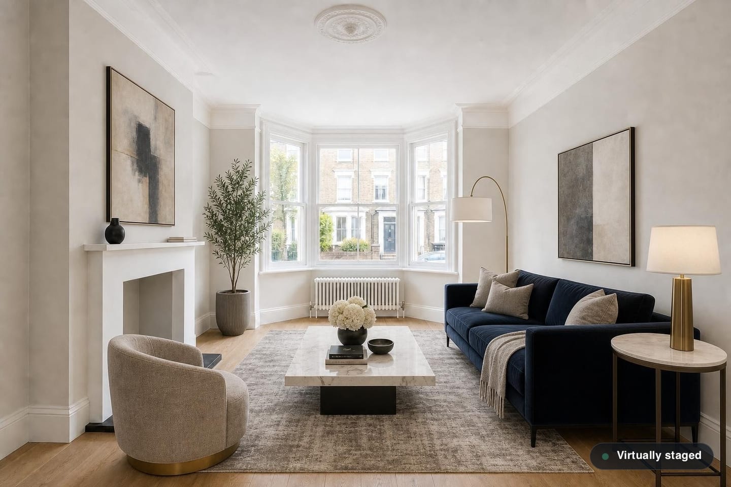 The same empty period living room, shown before and after virtual staging in a Luxury Contemporary scheme with a deep navy velvet sofa, marble-topped coffee table, cream swivel chair, brass floor lamp and a large abstract canvas — after